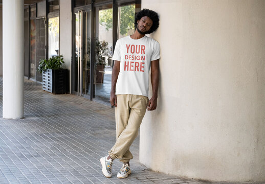 Mockup of man wearing customizable t-shirt by pillar