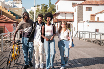 Obraz premium Group of friends walking together on the way to college. Concept: studies, education, friendship