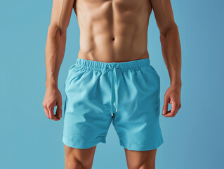 A man wearing blank blue swimming trunks shorts mockup isolating on blue background, for summer sport vacation