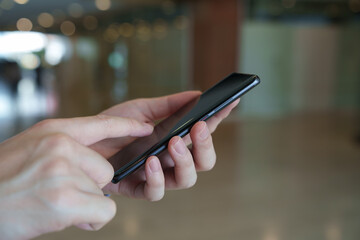 Man hand holding  mobile smartphone and typing or chatting conversation on internet networking. Technology, Communication and Social media marketing concept.