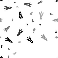 Seamless vector pattern with rockets, creating a creative monochrome background with rotated elements. Illustration on transparent background
