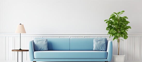 Grey lamp above white wooden coffee table next to blue elegant couch in bright living room interior...