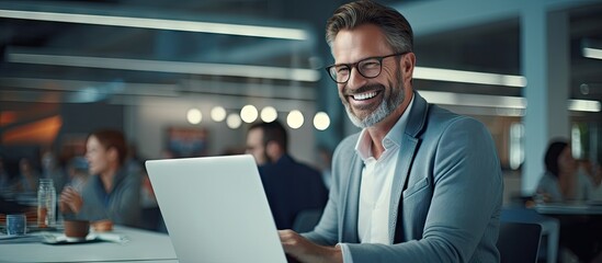 Happy mature business man executive manager looking at laptop computer watching online webinar or having remote virtual meeting video conference call negotiation corporate training working in o