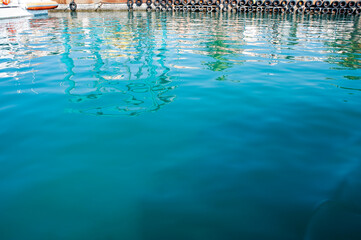 Turquoise water surface in the harbor. 