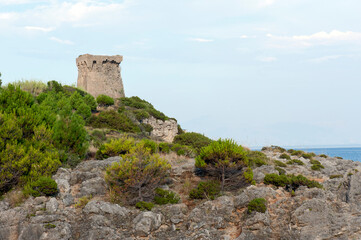 Fototapeta na wymiar Ancient ruined watchtower (mid-1500s ) on the cliff along the coast to prevent Saracen and pirates incursions. Marina di Camerota, Italy.