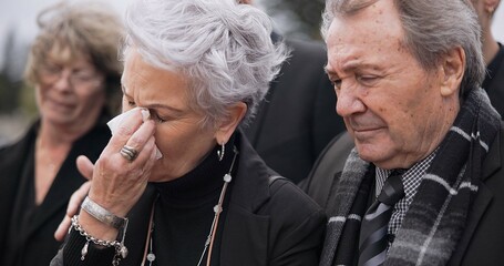 Death, funeral and senior couple crying together in pain or grief for loss during a ceremony or...