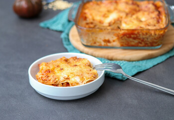 Homemade vegan Lasagne with soy meat and vegan cheese on a white plate