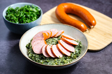 Traditional Dutch 'Boerenkool met worst stamppot'.  Mashed potatoes with kale and smoked sausage.