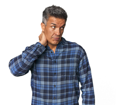 Middle-aged Latino man touching back of head, thinking and making a choice.