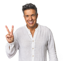 Middle-aged Latino man showing victory sign and smiling broadly.