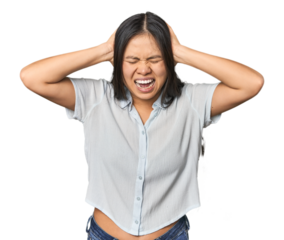 Young chinese woman isolated covering ears with hands trying not to hear too loud sound.