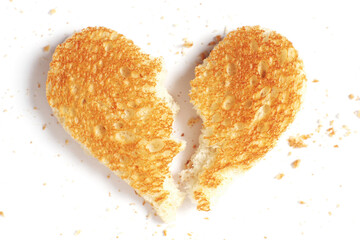 A heart-shaped piece of toasted bread broken in half
