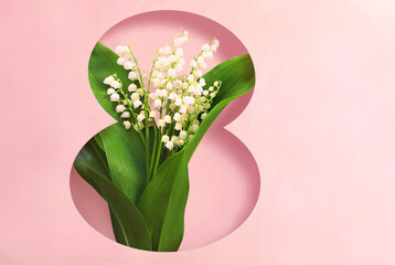 Card for Women's Day March 8 with bouquet of spring lily of the valley flowers on pink background inside the number eight.