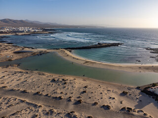 West coast of Fuerteventura island. Winter sea and sun vacation in El Cotillo touristic village, Canary islands, Spain. White sandy beach La Concha..