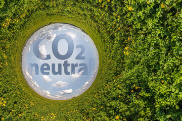 CO2 Neutral text concept image against blue little planet in green grass background