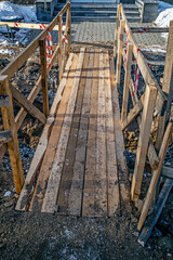 Temporary wooden pedestrian bridge on a winter day