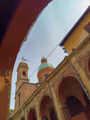Exterior arcades in perspective with dome and bell tower of San Bartolomeo and Gaetano church, Bologna ITALY