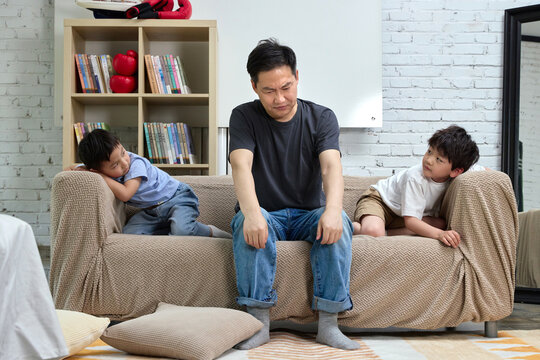 Father and children playing on the sofa