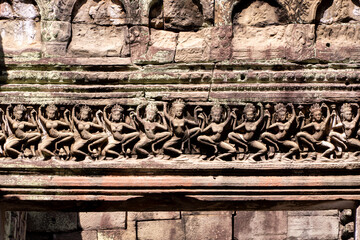 Carvings on walls of the ancient Angkor Wat temple of Khmer women dancing. UNESCO world heritage site