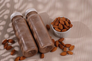 Chocolate flavored almond milk in a plastic bottle. made from almonds, chocolate, water and sugar. suitable for vegetarians and vegans as well as people who are allergic to cow's milk. susu coklat. 