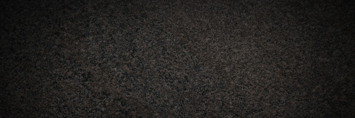 Dark granite texture. Natural granite with a grainy pattern. Solid rough surface of rock with...