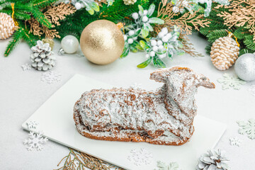 Christmas lamb cake with traditional New Year decor. Baked sweet dessert with sugar icing