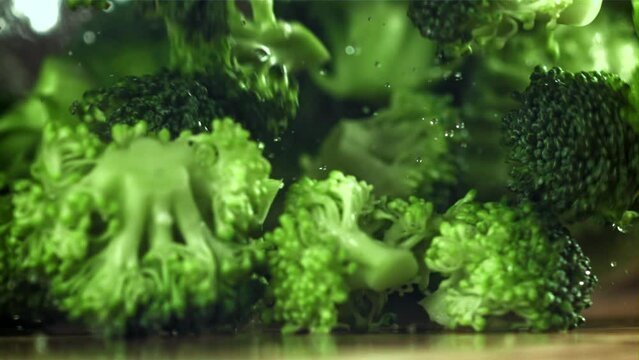 Dropping broccoli with splashing water. Filmed on a high-speed camera at 1000 fps. High quality FullHD footage