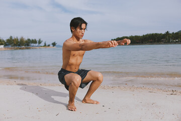 Fototapeta na wymiar Active Asian Athlete Enjoying Beach Fitness Training at Sunset