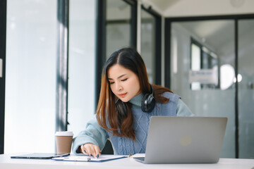 Woman freelancer is working her job on computer tablet and laptop Doing accounting analysis report real estate investment data, Financial