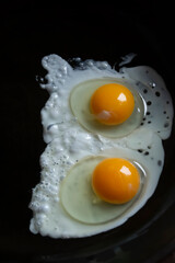 Scrambled eggs in a black pan. English breakfast - fried eggs with two eggs. fried eggs.