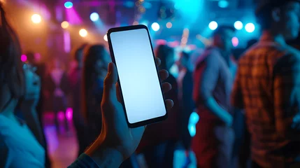 Foto op Canvas Hand holding an isolated smartphone device with blank empty white screen at a party in pub disco, travel business communication technology concept © BeautyStock