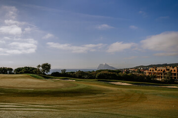 Sotogrande, Spain - January, 23, 2024 - Golf course with mowed fairways, a view of the Rock of...