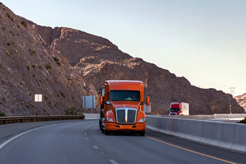 The truck is moving along the road, front view