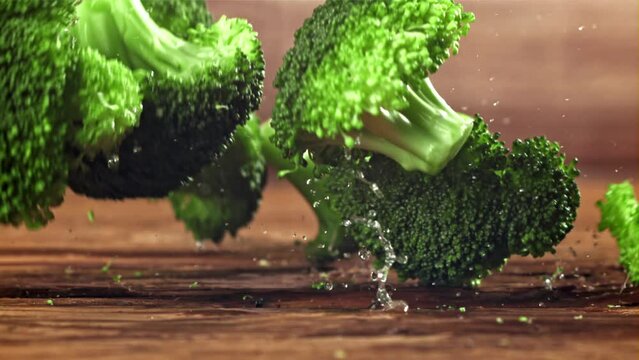 Dropping broccoli with splashing water. Filmed on a high-speed camera at 1000 fps. High quality FullHD footage