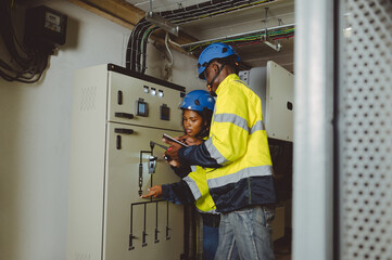 engineering technician Setting up the solar panel inverter in the electrical room Service engineer installs solar cells on factory roofs Concept of clean energy and renewable energy