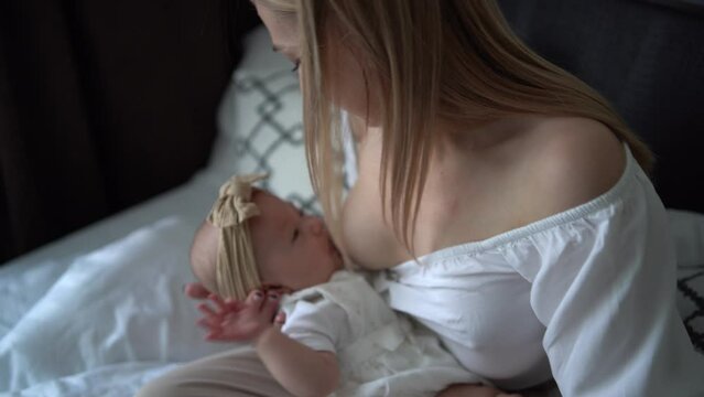 Caucasian mother brestfeed her child