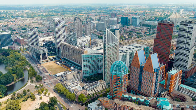 The Hague, Netherlands - July 21, 2023: Business center of The Hague. Large train station Den Haag Centraal. Cloudy weather. Summer day, Aerial View