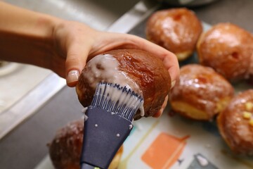 Making sugar glazed Polish donuts