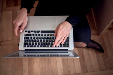 woman work with laptop on the floor