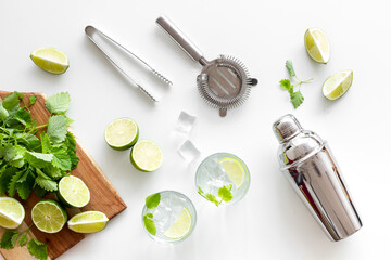 Bartenders tools blender with mint and lime for refreshing cocktail mojito, top view