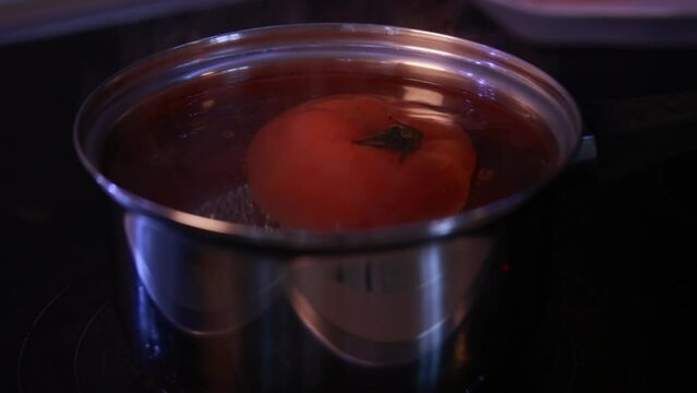 blanch tomato in boiling water close-up