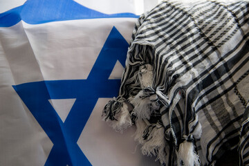 Israel flag and Palestinian scarf together lying on a rope to dry after washing or lying on a...