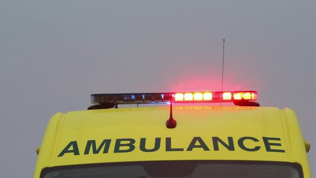 Red and blue flasher on roof of yellow ambulance car of emergency medical service. .