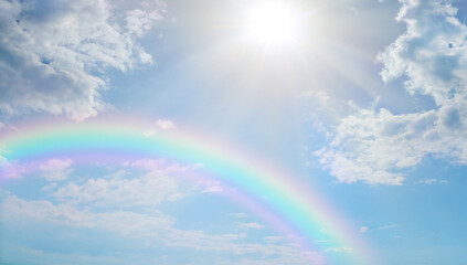 Soft beautiful rainbow sky spiritual background -  blue sky with pretty clouds, a bright sun...