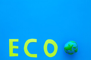 Clay plasticine globe planet Earth and paper word Eco. Protection ecology concept. Kids creativity