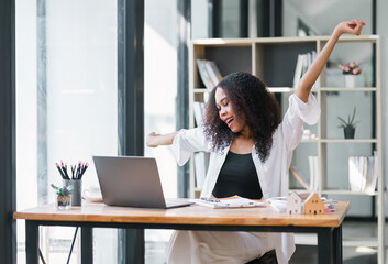 Joyful African American Businesswoman Stretching at Workplace.