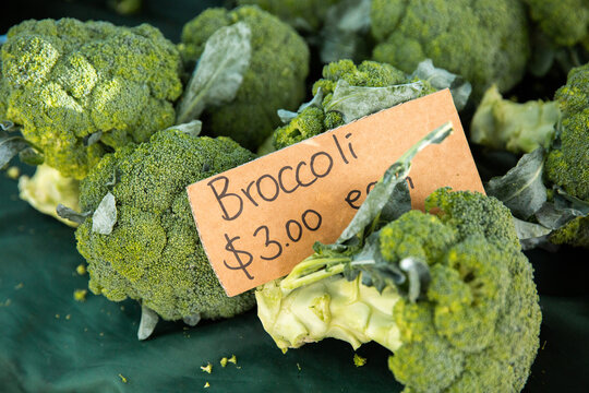 broccoli for sale at the farmers markets with a cardboard sign
