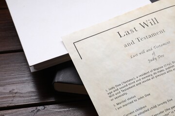 Last Will and Testament with books on wooden table, closeup