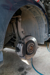 Closeup of steel brake disc in car service.