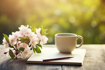 Tuinposter Coffee cup and spring blossom sakura on wooden table © gographic